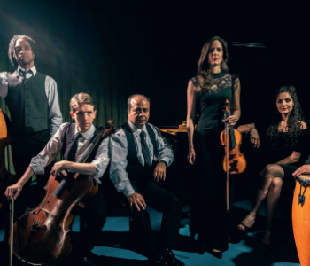 group of five musicians stood and sat holding instruments