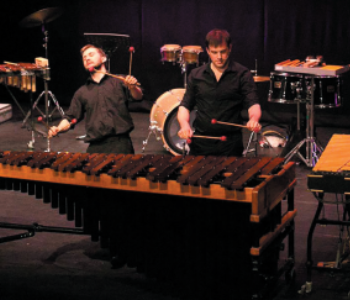 two people playing a giant xylophone