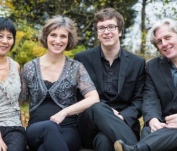 group photo of four people sat outside